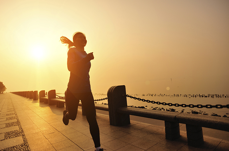 healthy lifestyle asian woman running at seaside